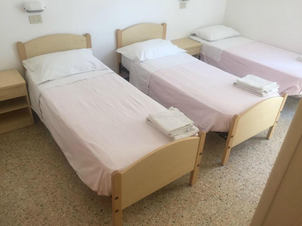 Postel nebo postele na pokoji v ubytování Hotel Ronconi