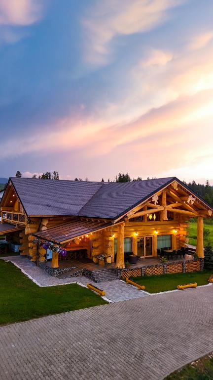 a large log house with a gambrel roof at Prosilva House Banffy 2 in Topliţa