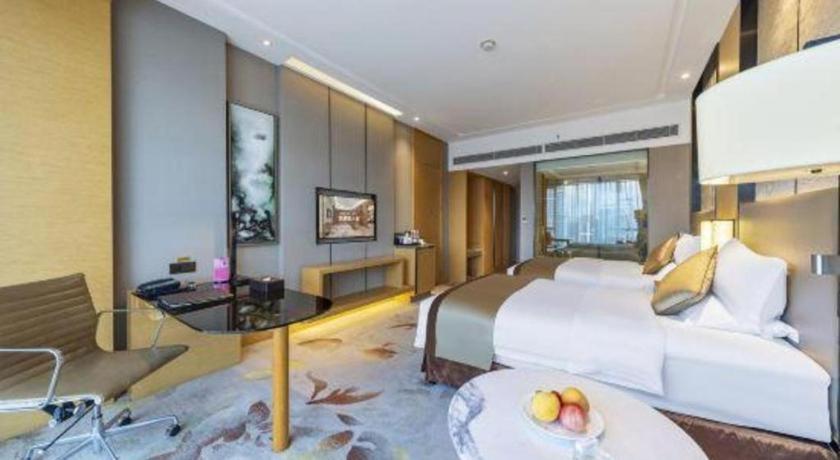 Ένα ή περισσότερα κρεβάτια σε δωμάτιο στο Xincheng hotel