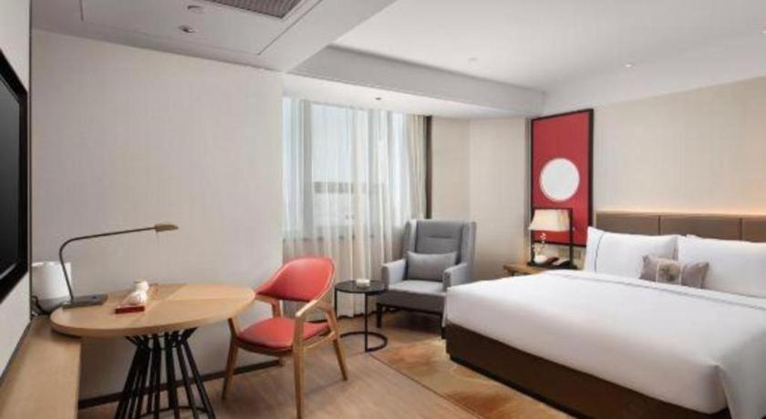 Postel nebo postele na pokoji v ubytování E-Cheng Hotel Shenyang North Railway Station