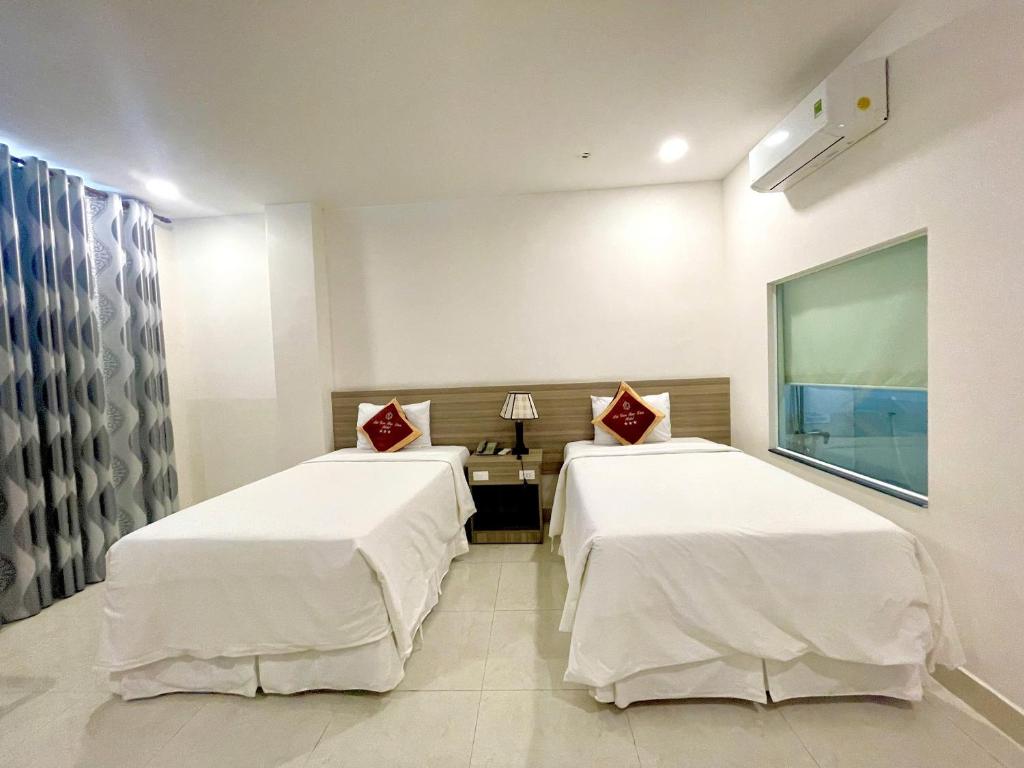 Postel nebo postele na pokoji v ubytování SÀI GÒN - BẠC LIÊU Hotel