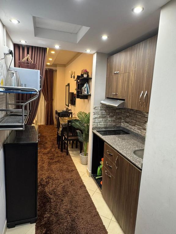 a kitchen with a counter and a dining room at كمباوند فلورينزا 50 in Hurghada
