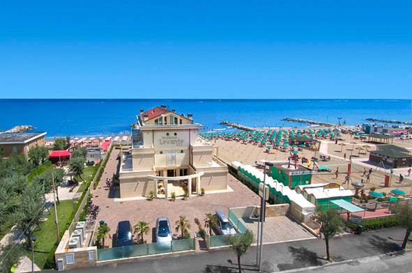 a building on a beach with the ocean in the background at Residence Levante in Misano Adriatico