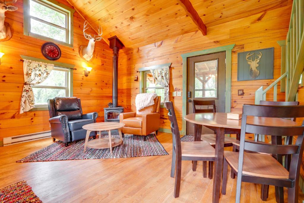 a living room with a table and chairs in a cabin at On 30 Acres with Trails and Garden Stockholm Retreat! in Stockholm