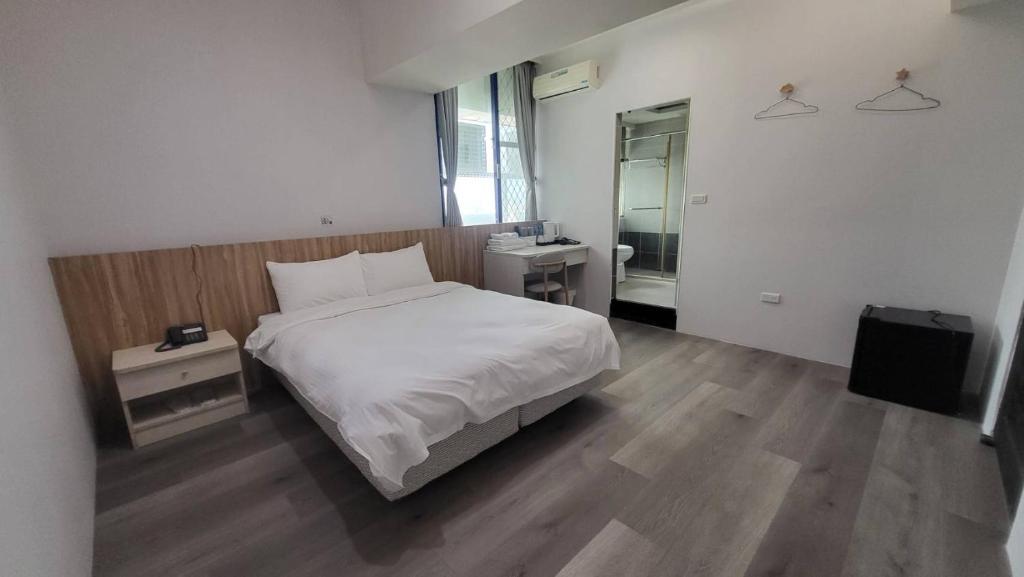 Krevet ili kreveti u jedinici u okviru objekta Xingyi Hotel