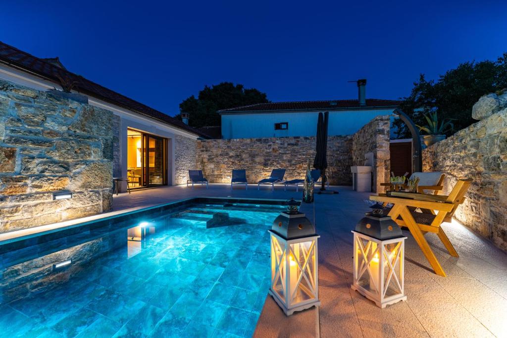 a swimming pool in the backyard of a house at Cortile House in Pridraga