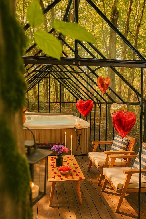 a glassconservatory with red hearts hanging from the ceiling at Montebello Chalet in Porumbacu de Sus