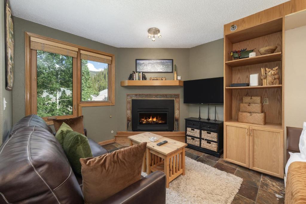 a living room with a couch and a fireplace at Iron Horse C4093 condo in Winter Park