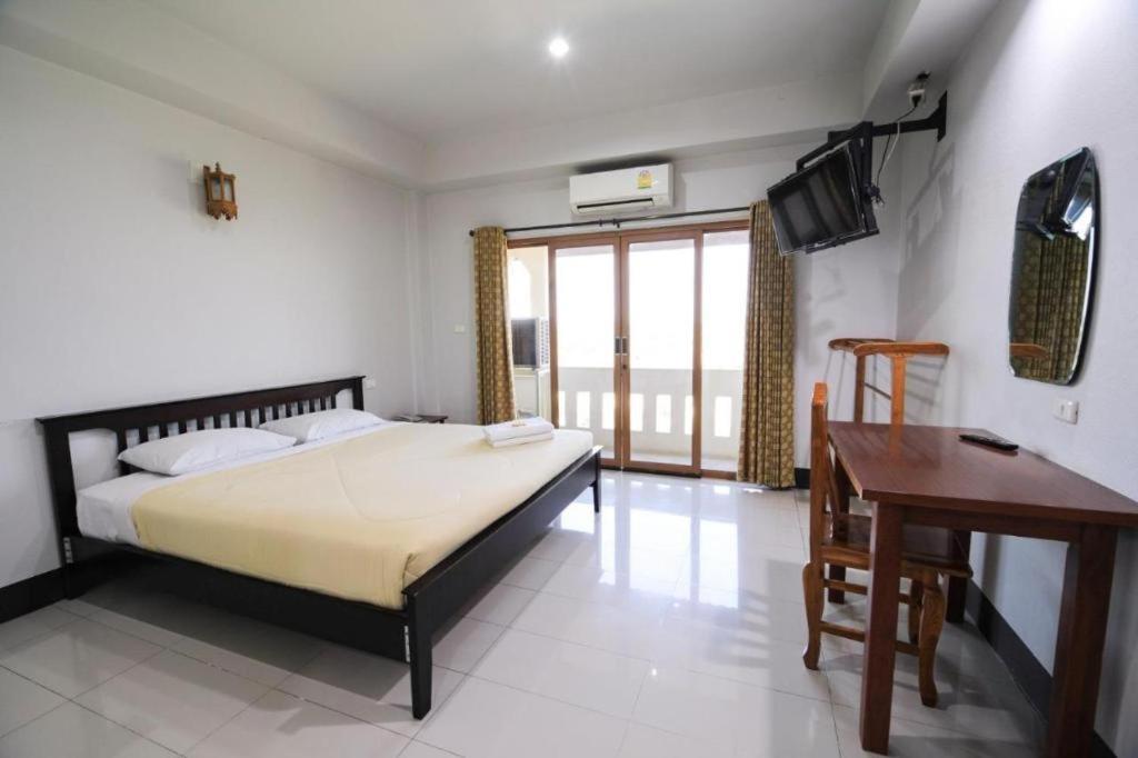 Ένα ή περισσότερα κρεβάτια σε δωμάτιο στο AmornSukhothai Hotel