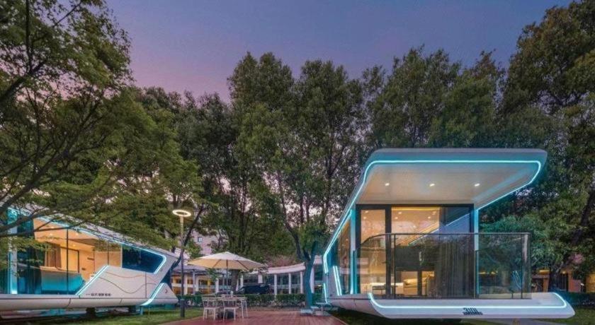 a house with a blueructure sitting in a park at New Century Grand Hotel Xuzhou in Xuzhou