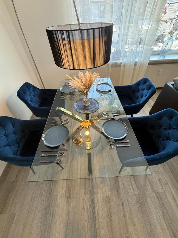 a glass table with a lamp on top of it at Stillvoll inklusive Sauna und Whirlpool in Daaden