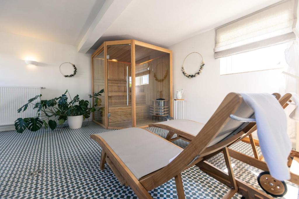a living room with a chair and a cabinet at Landhaus Paco Familienferien mit Sauna und Kamin in Blaufelden