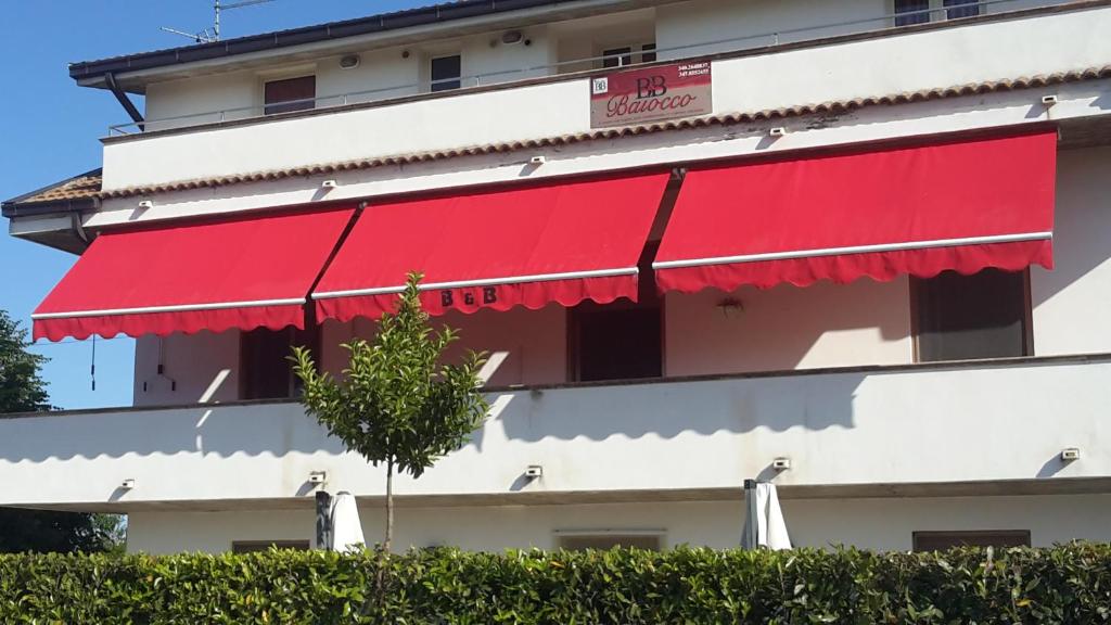 a red awning on the side of a building at Belvedere Baiocco in Pianella