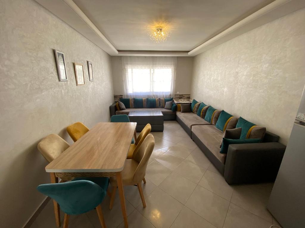 a waiting room with a table and chairs at Holidays in Martil - Beach, comfort and safety in Martil