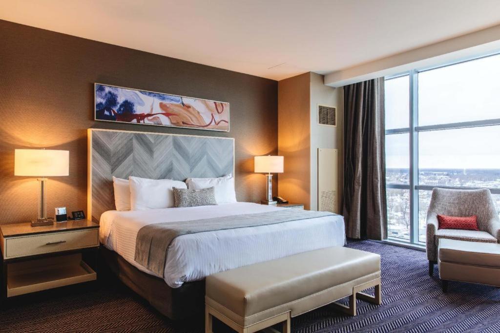 a hotel room with a bed and a large window at Blue Chip Casino Hotel Spa in Michigan City