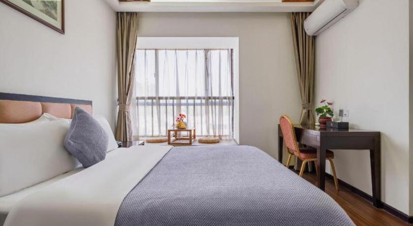 Postel nebo postele na pokoji v ubytování Oriental Hotel
