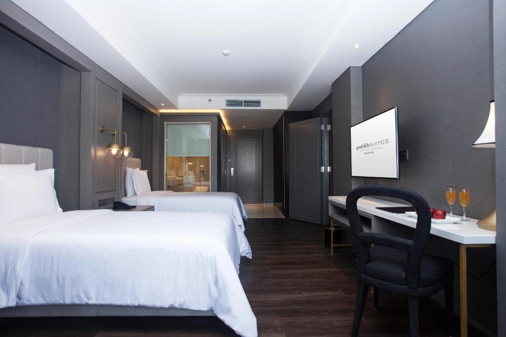 Postel nebo postele na pokoji v ubytování Goodrich Suites, Jakarta