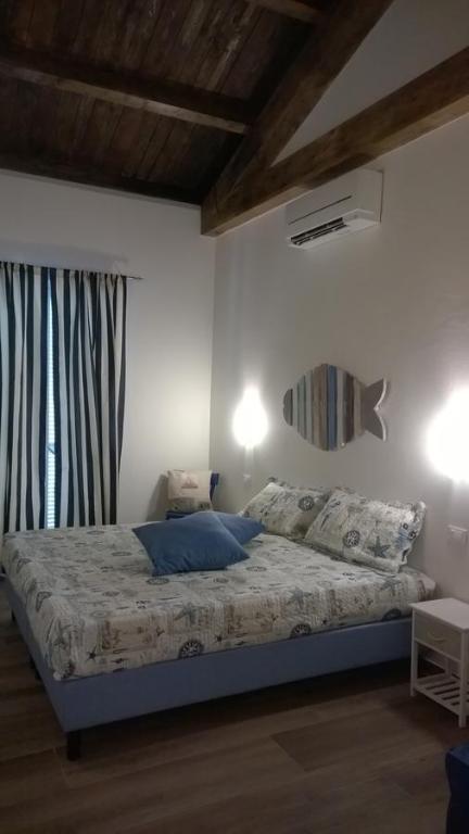 a bedroom with a bed and two lights on the wall at Il Porto dei Sognatori in La Spezia