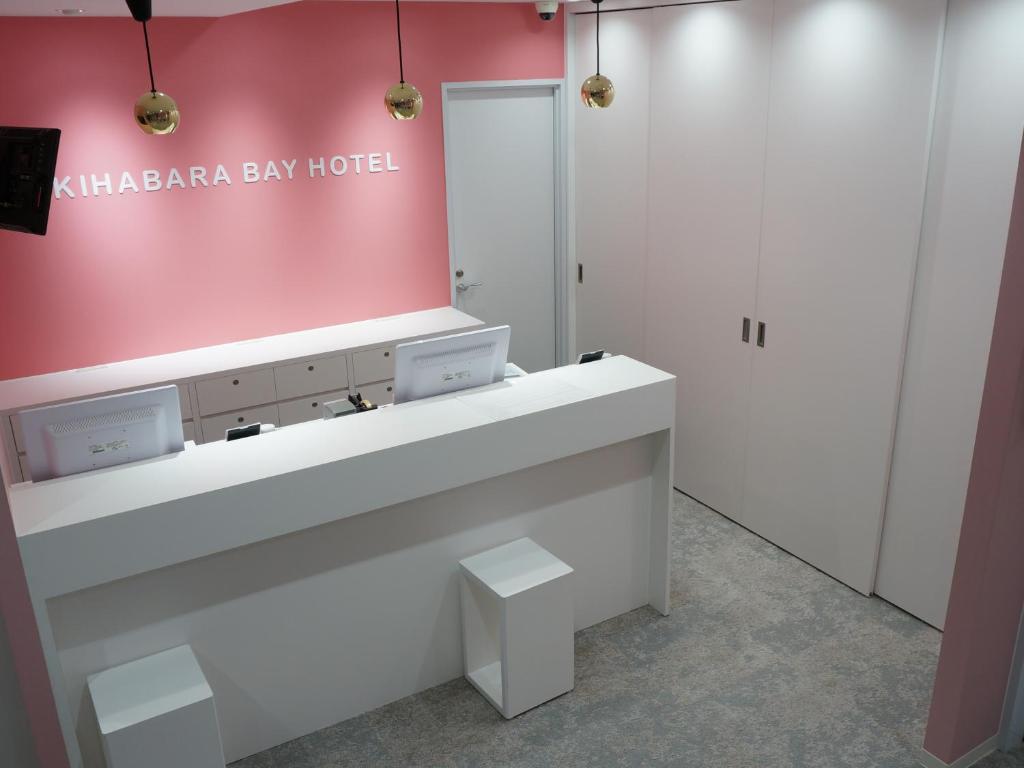 a bathroom with a sink and a pink wall at Akihabara Bay Hotel (Female Only) in Tokyo