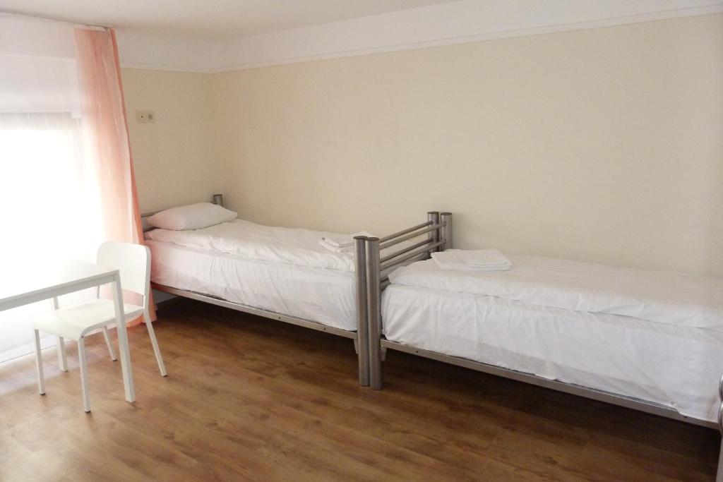 A bed or beds in a room at Center Hostel and Guest House