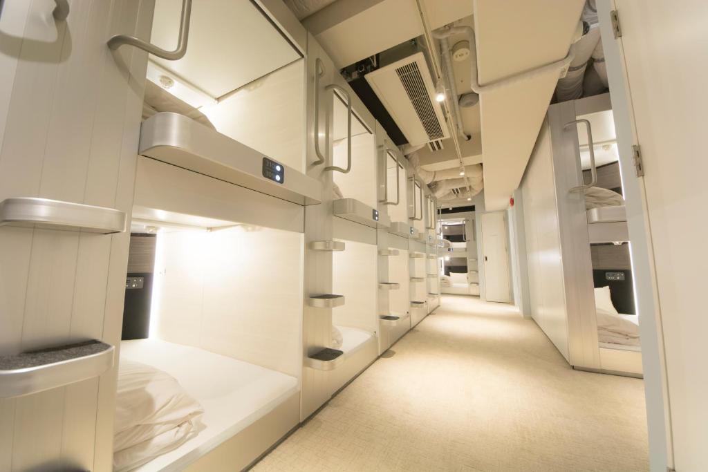 a corridor of a hospital room with white walls at Akihabara Bay Hotel (Female Only) in Tokyo