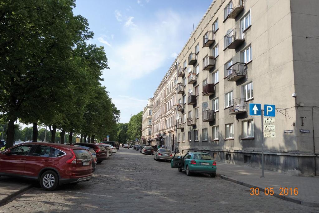 a street with cars parked on the side of a building at Apartment Old Town Riga River View in Riga