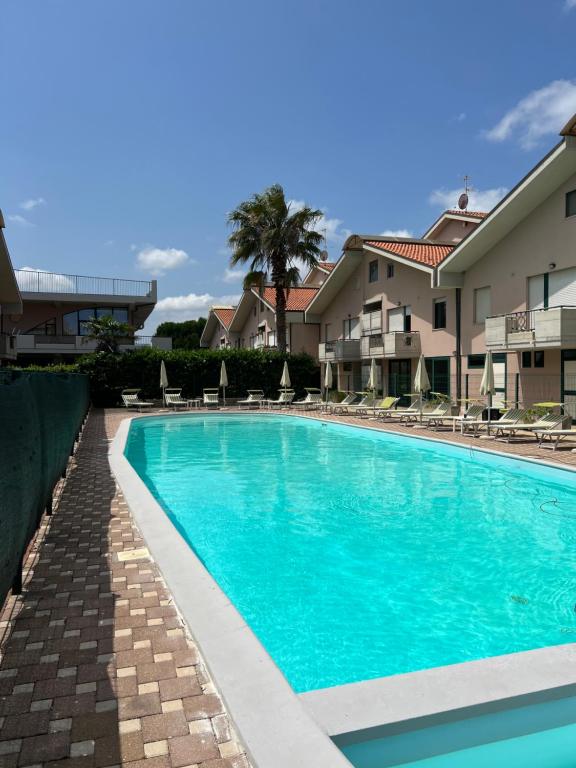 a swimming pool in front of some apartment buildings at Maison Belle Montenero Marina in Marina di Montenero