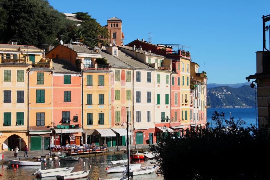 a group of buildings with boats in the water at Clara's House in Portofino