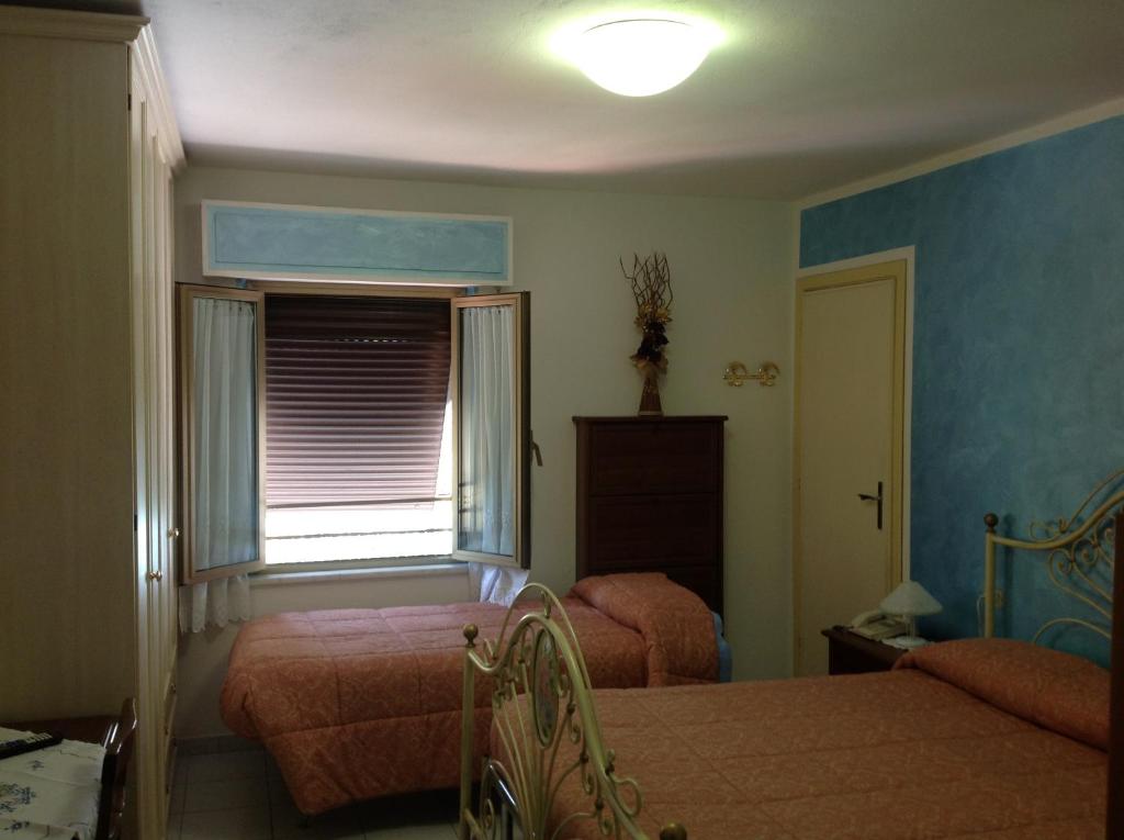 Postel nebo postele na pokoji v ubytování Albergo Elisa