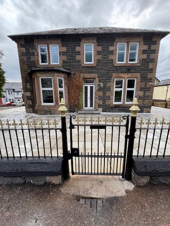 a black fence in front of a house at Strathmore Guest house in Fort William