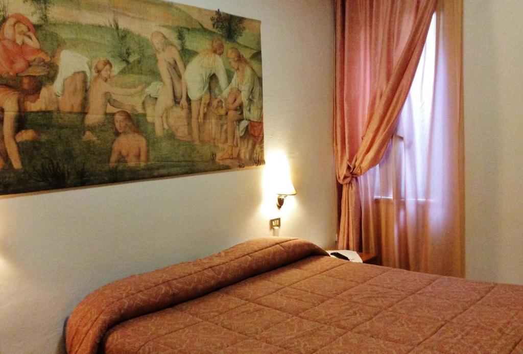 Postel nebo postele na pokoji v ubytování Albergo Elisa