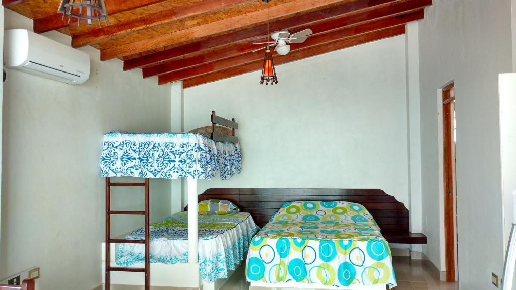 a bedroom with a bunk bed and a ladder at Bella Vista condominio in Canoas De Punta Sal