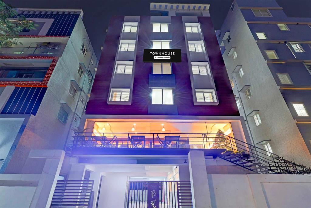 a tall building with a balcony in front of it at Townhouse Oak Visakhapatnam Lumbini Park in Visakhapatnam
