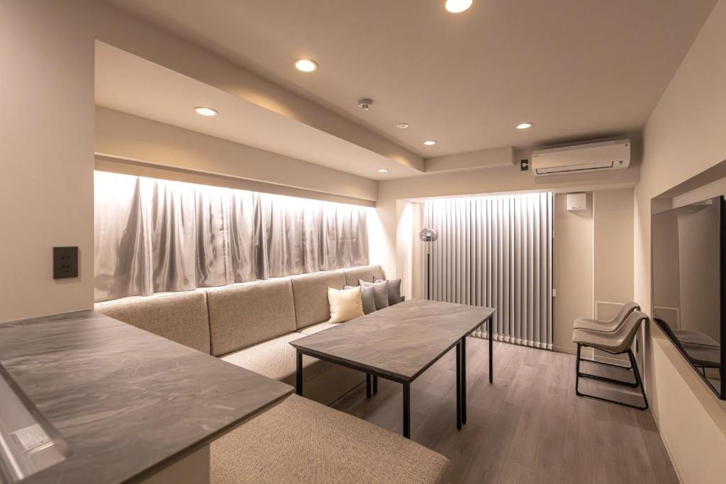 una sala de estar con un sofá y una mesa en Crest Tenma 2nd, 3rd, 4th floors - Vacation STAY 42276v, en Osaka