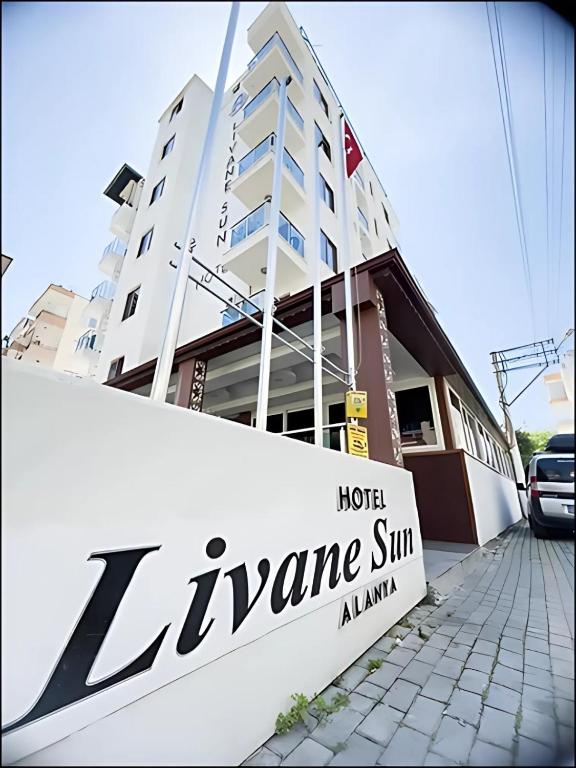 a hotel name sign in front of a building at Livane Sun Otel in Alanya