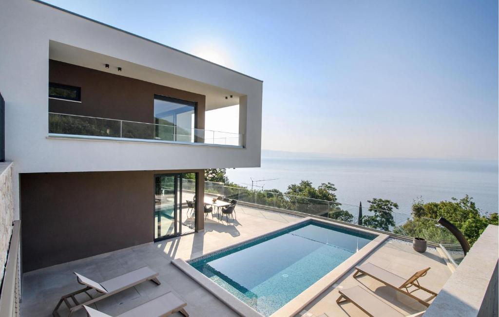 a house with a swimming pool and a balcony at Stunning Home In Medveja in Medveja