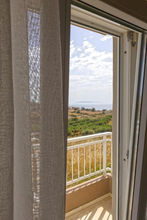 a window with a view of the ocean at Pelagia Bay Hotel in Agia Pelagia