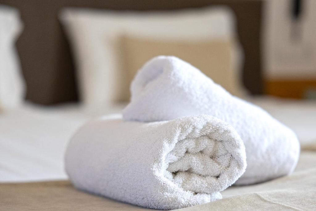 a pile of white towels sitting on a table at Pelagia Bay Hotel in Agia Pelagia