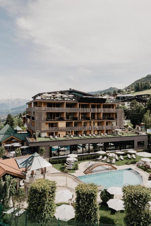 a hotel with a swimming pool and a resort at Hotel Berghof - St Johann in Salzburg in Sankt Johann im Pongau