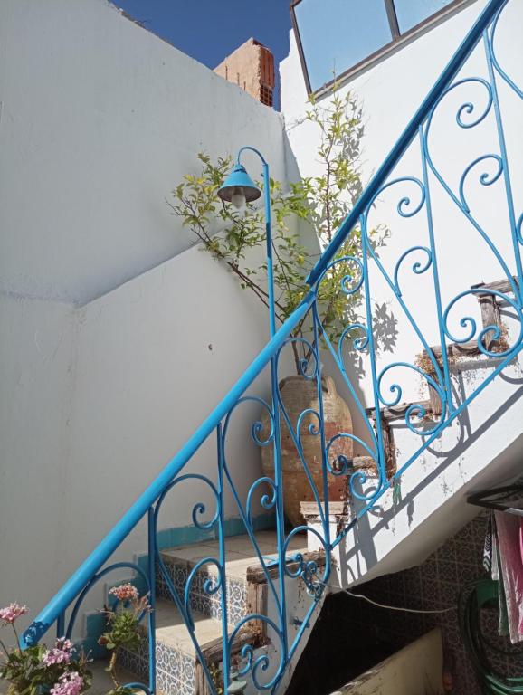 a stairway with blue railings and plants at Dar Warda in Bizerte