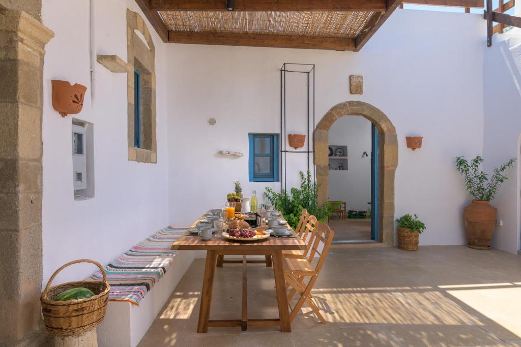 a wooden table in the middle of a patio at White House 1871 in Lachania