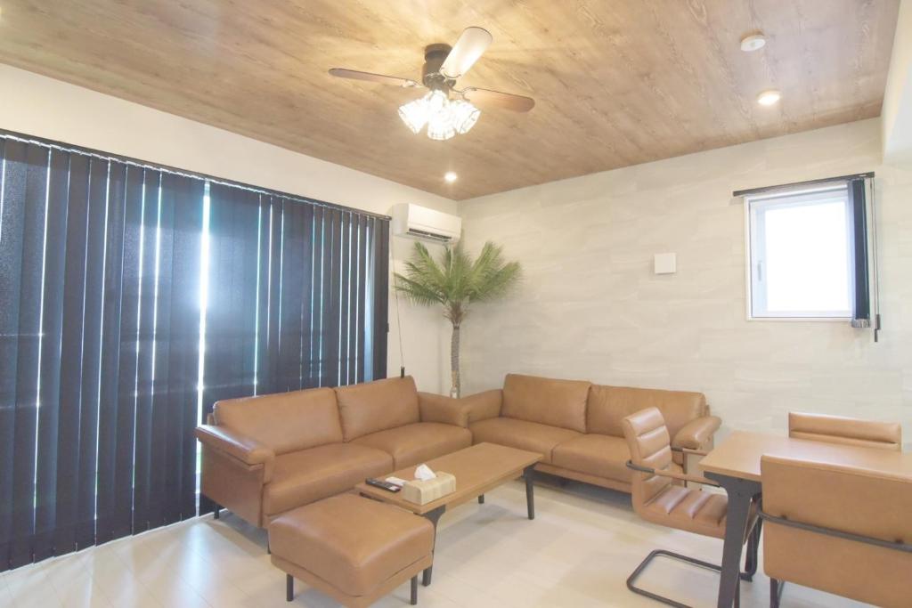 a living room with a couch and a table at at60% - Vacation STAY 53162v in Nishibaru