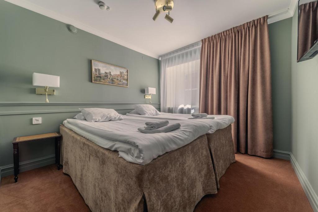 Postel nebo postele na pokoji v ubytování Best Western Strand Hotel
