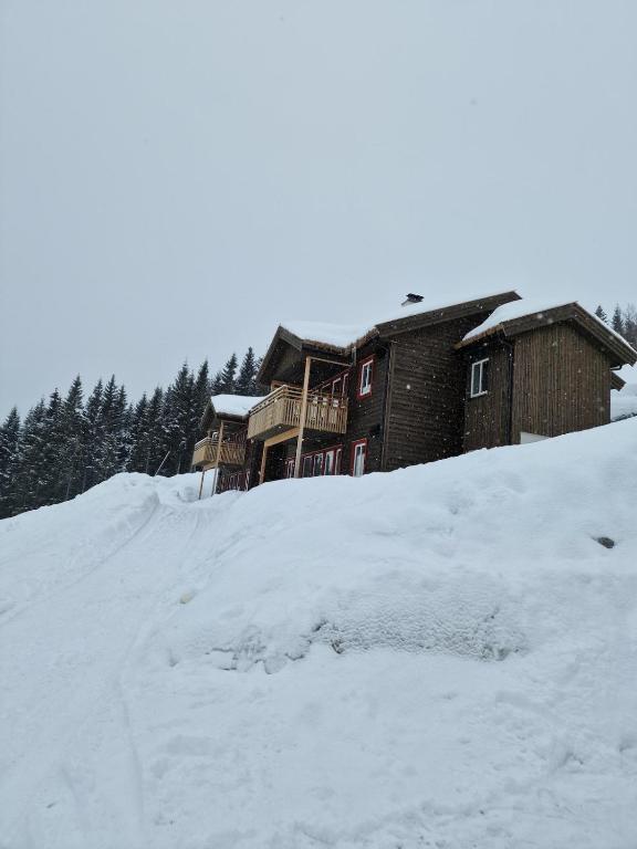 a house on top of a snow covered hill at Apartment in Voss - Tråstølen in Skulestadmo