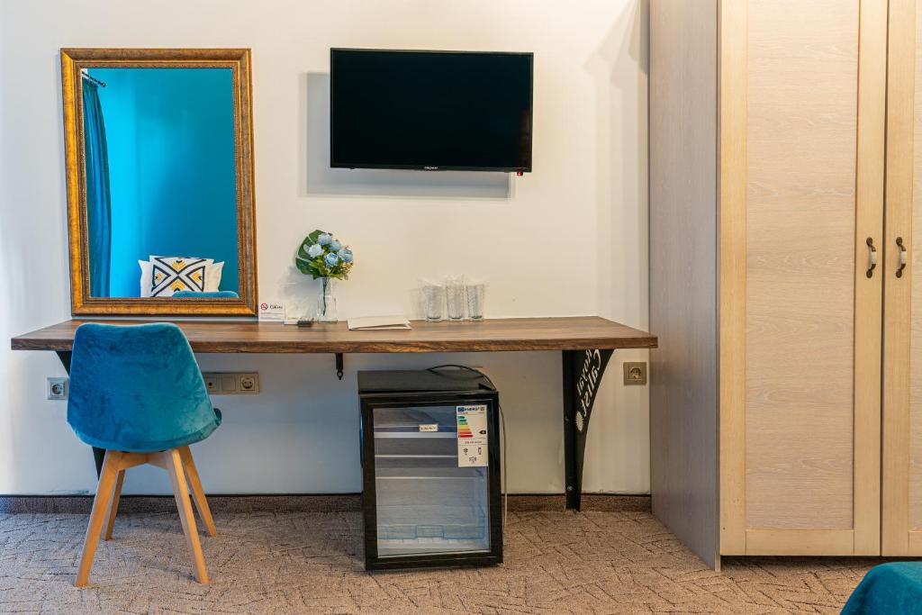 TV a/nebo společenská místnost v ubytování Royal Calisto Hotel