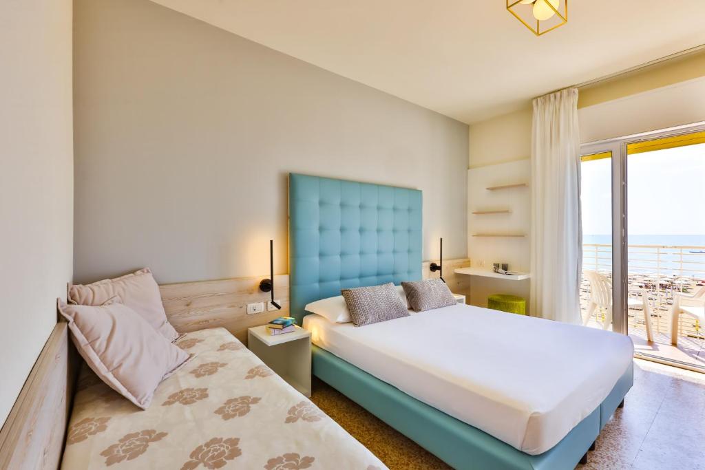 Postel nebo postele na pokoji v ubytování Hotel Ariston