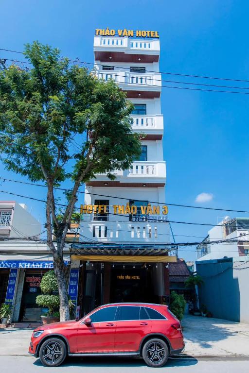 a red car parked in front of a building at Thảo Vân 3 Hotel in Danang