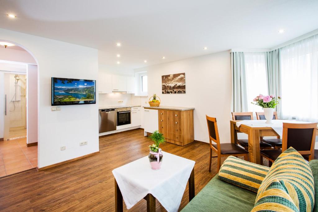 a living room with a couch and a table at Old Town City Center Apartment Post in Zell am See