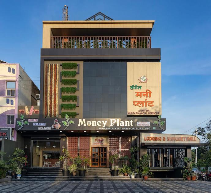 a building with a money plant sign on it at Hotel Money Plant in Jogeshwāri