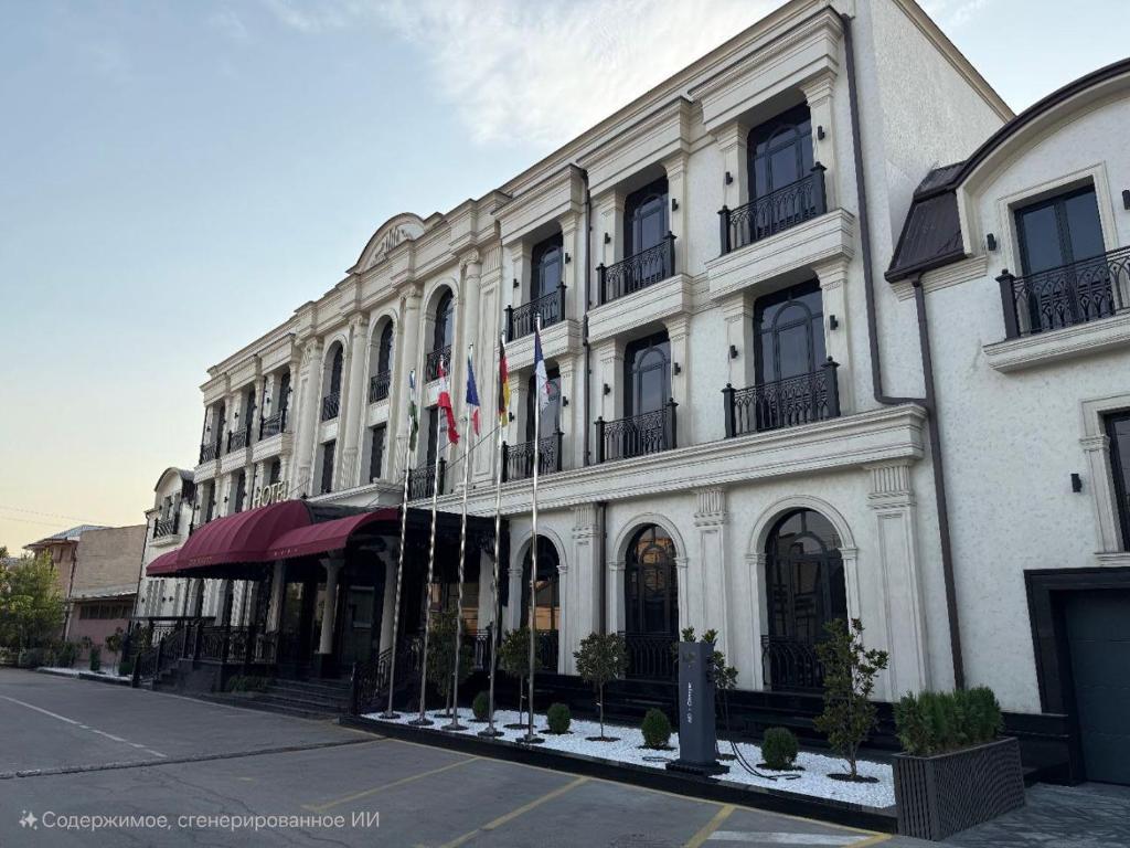 a large white building with flags in front of it at FRANKFORT Expo Hotel in Tashkent
